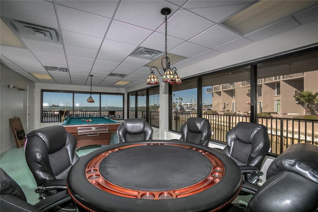 632 Edgewater Drive, Unit 235 Dunedin, FL 34698 - Photo 30 of 37 a room with furniture and a chandelier