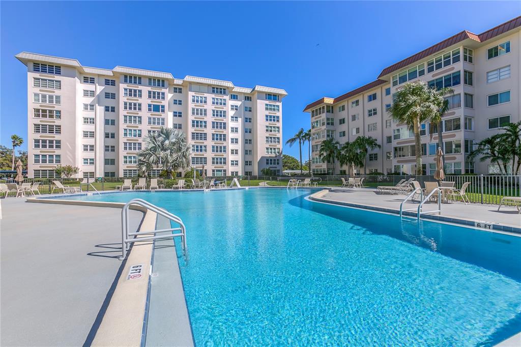 632 Edgewater Drive, Unit 235 Dunedin, FL 34698 - Photo 32 of 37 a view of building with yard and swimming pool