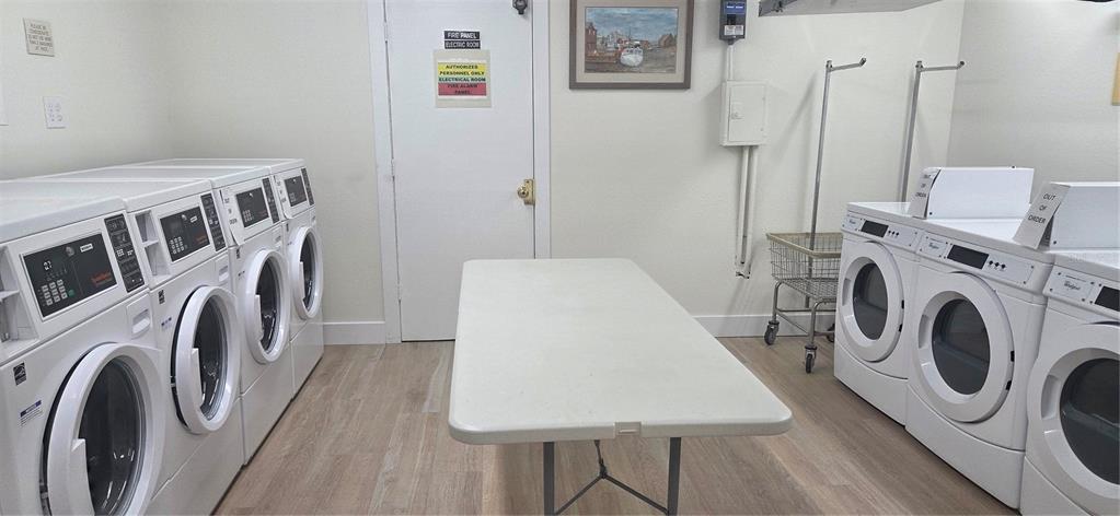 632 Edgewater Drive, Unit 235 Dunedin, FL 34698 - Photo 34 of 37 a utility room with dryer washer and a view of kitchen
