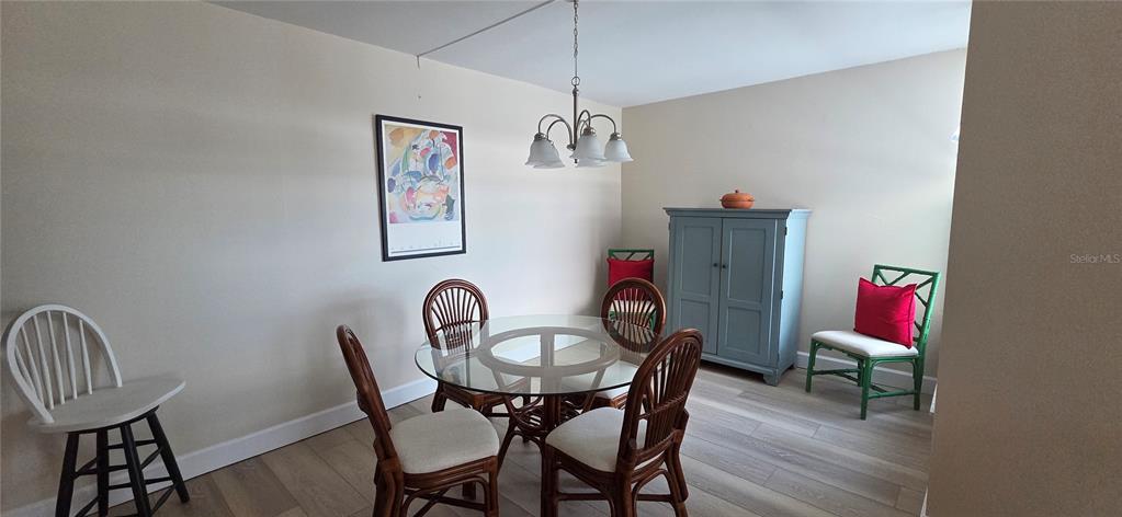 632 Edgewater Drive, Unit 235 Dunedin, FL 34698 - Photo 36 of 37 a view of a dining room with furniture and wooden floor