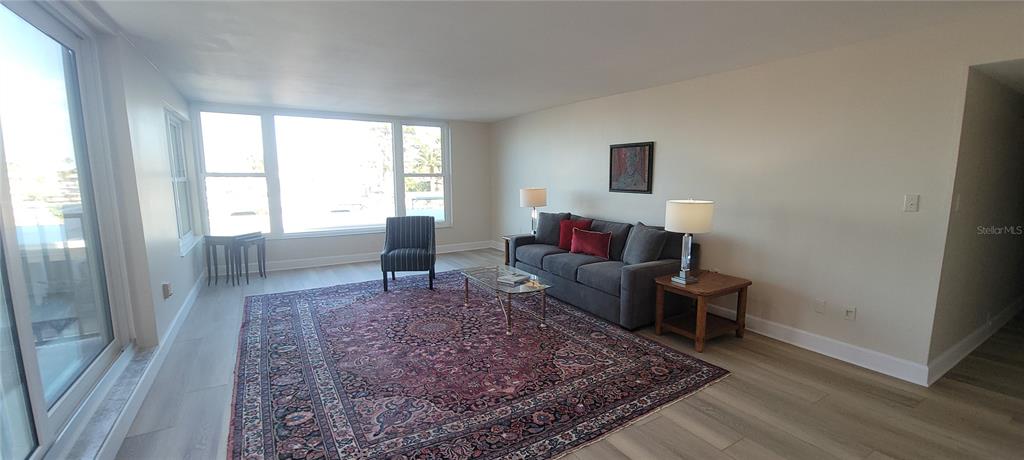 632 Edgewater Drive, Unit 235 Dunedin, FL 34698 - Photo 4 of 37 a living room with furniture and a rug