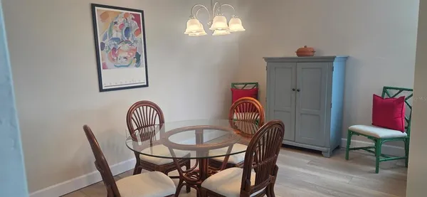 a view of a dining room with furniture wooden floor and a chandelier