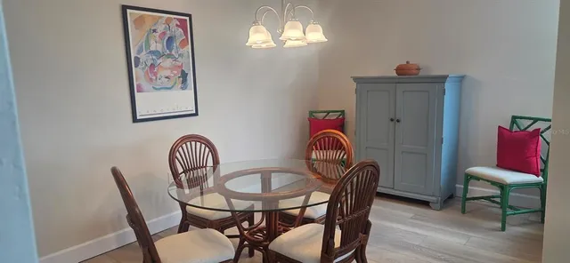 a view of a dining room with furniture wooden floor and a chandelier
