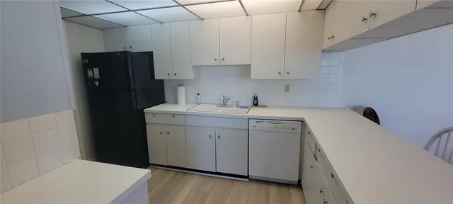 a utility room with cabinets washer and dryer