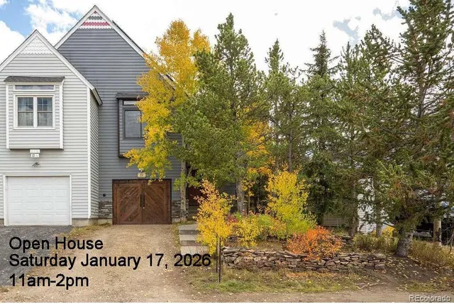 a view of a wooden house next to a yard