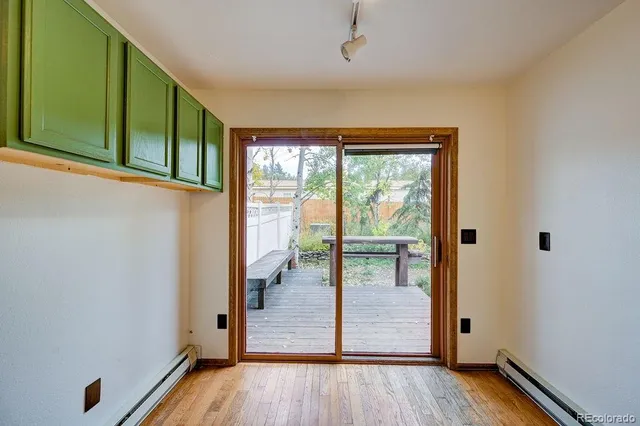 a view of empty room with wooden floor