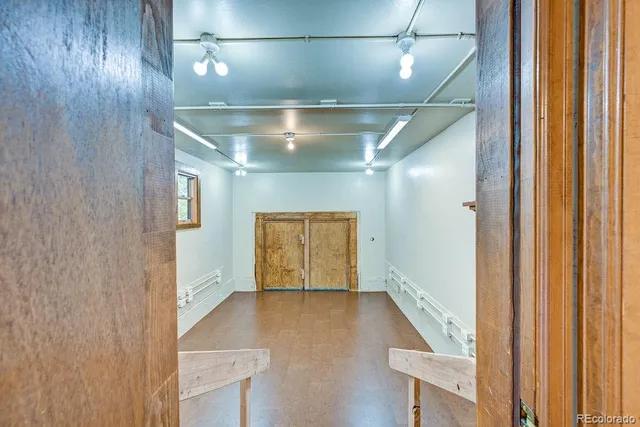 a view of hallway with stairs and wooden floor