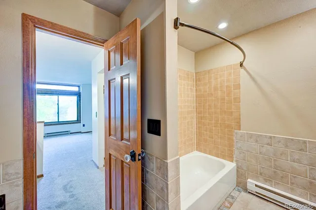 a bathroom with a tub and a shower