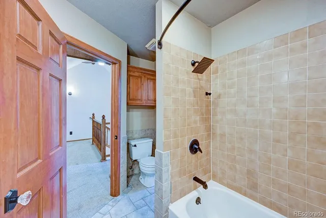 a bathroom with a tub and shower