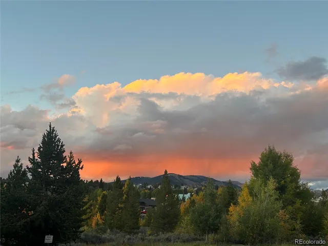 a view of a patio with table and chairs under an umbrella