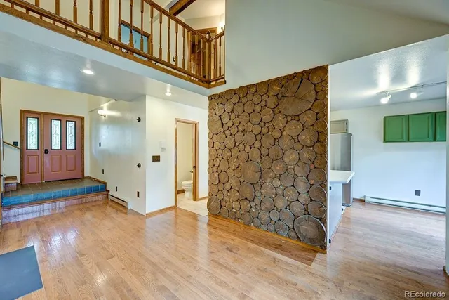 a view of an entryway with wooden floor