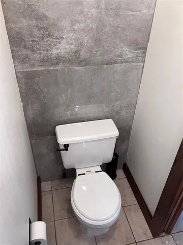 a white toilet sitting next to a small bathroom
