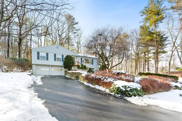 a view of a house with a yard covered in snow