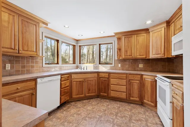 a kitchen with stainless steel appliances granite countertop a stove sink and cabinets