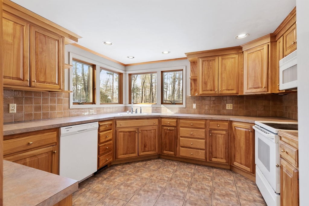 7 Kelley Road Acton, MA 01720 - Photo 6 of 14 a kitchen with stainless steel appliances granite countertop a stove sink and cabinets