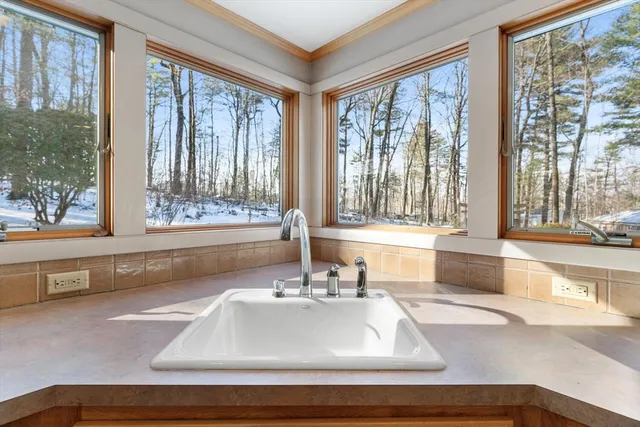 a bathroom with a sink and a large window