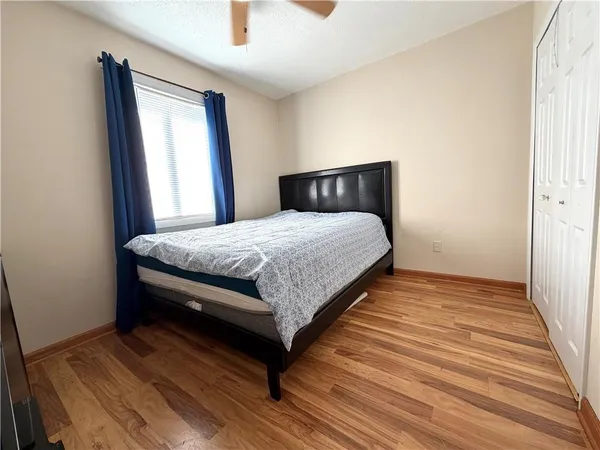 a bedroom with a bed and window