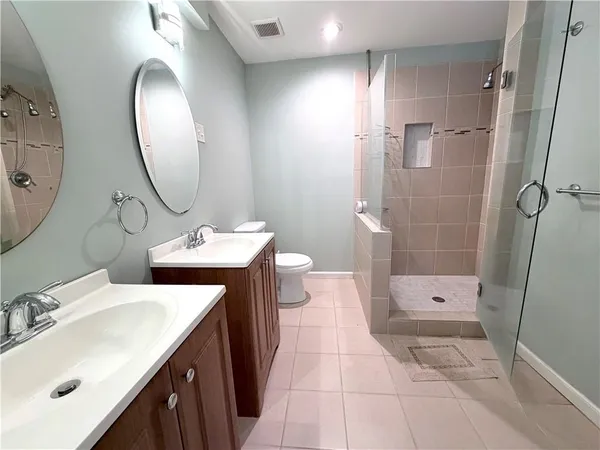 a bathroom with a sink a toilet and shower