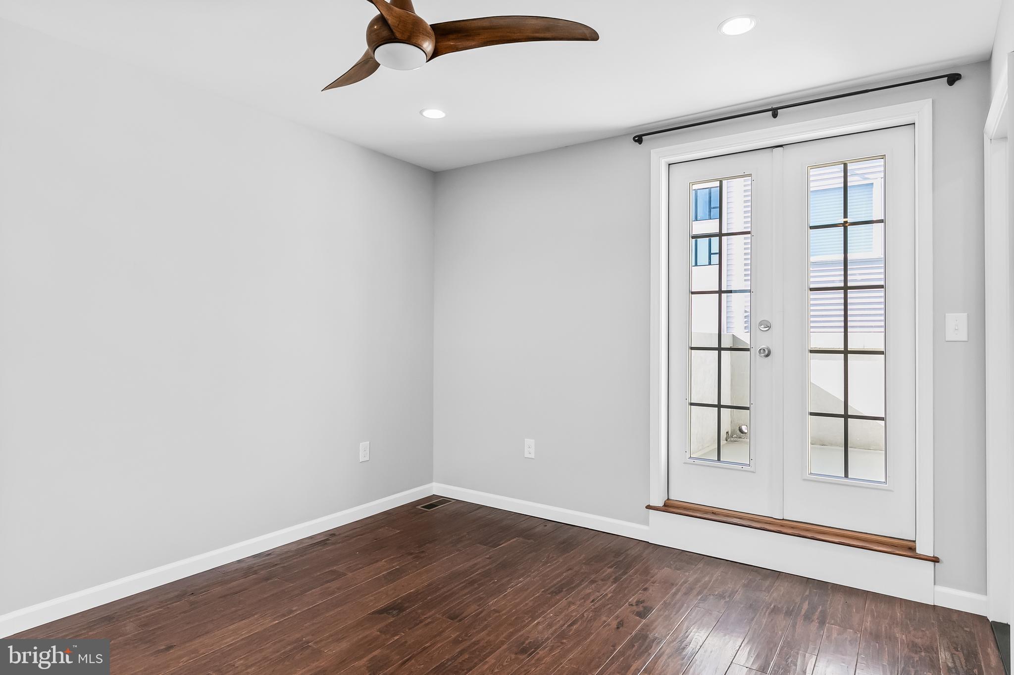 1120 O'Neil Street Philadelphia, PA 19123 - Photo 17 of 27 an empty room with wooden floor cabinet and windows
