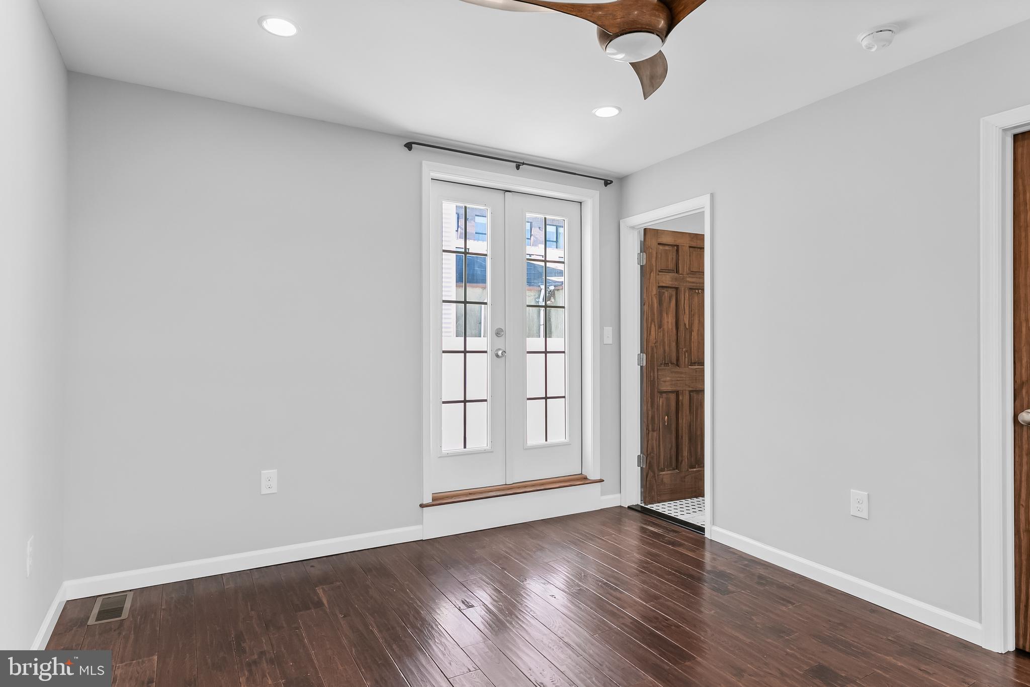 1120 O'Neil Street Philadelphia, PA 19123 - Photo 19 of 27 an empty room with wooden floor cabinet and windows