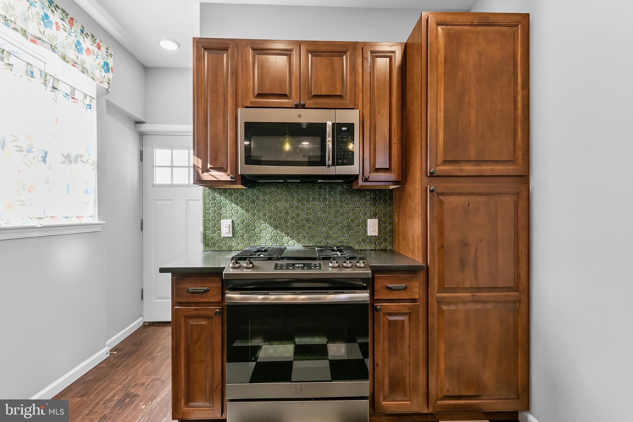 1120 O'Neil Street Philadelphia, PA 19123 - Photo 2 of 27 a kitchen with a stove and a microwave