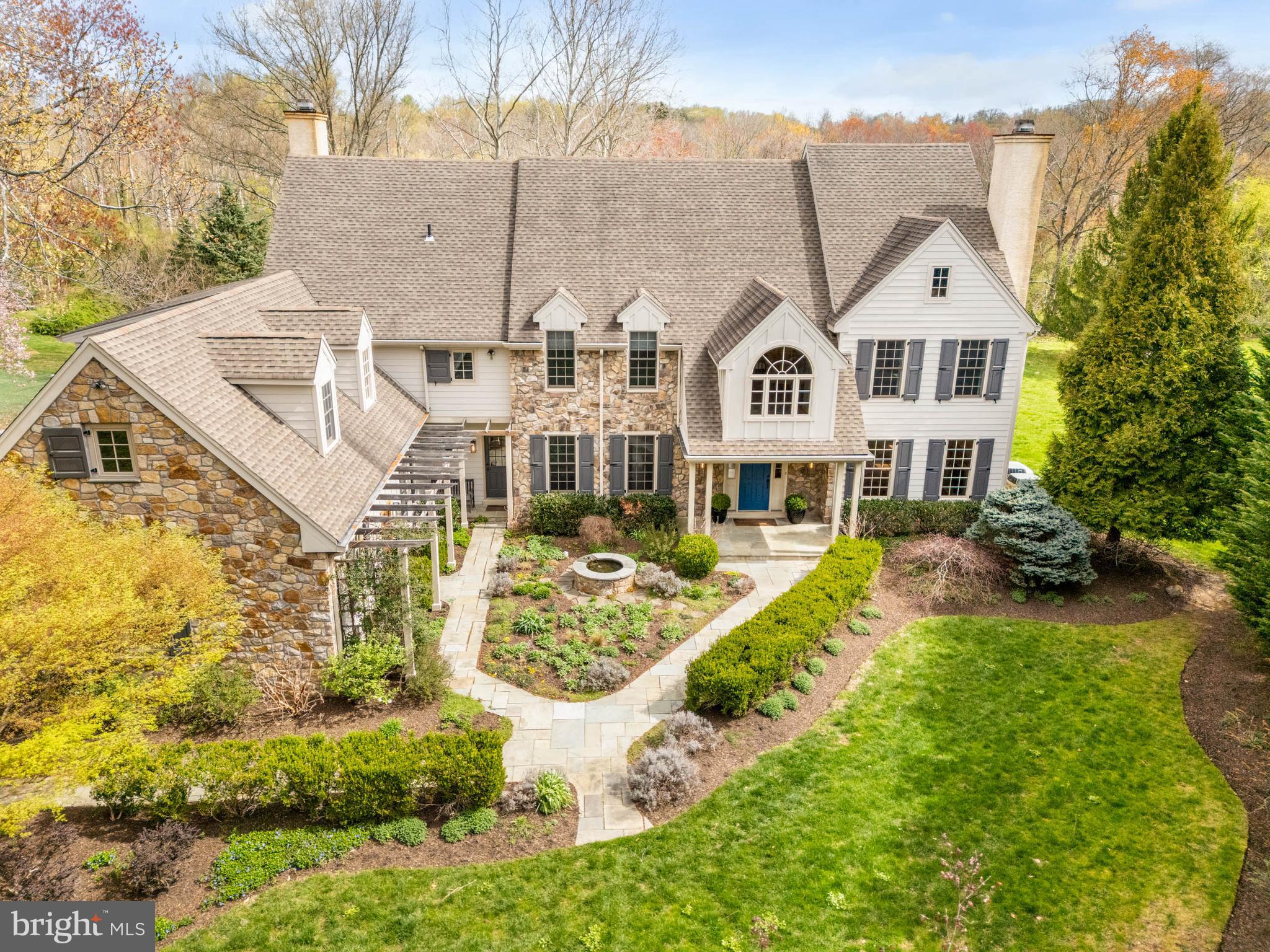 a front view of a house with a big yard and potted plants