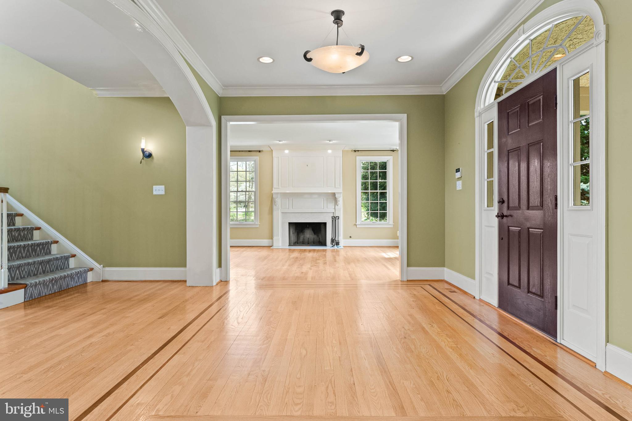 607 Newtown Road Berwyn, PA 19312 - Photo 12 of 83 a view of an empty room with wooden floor and a fireplace