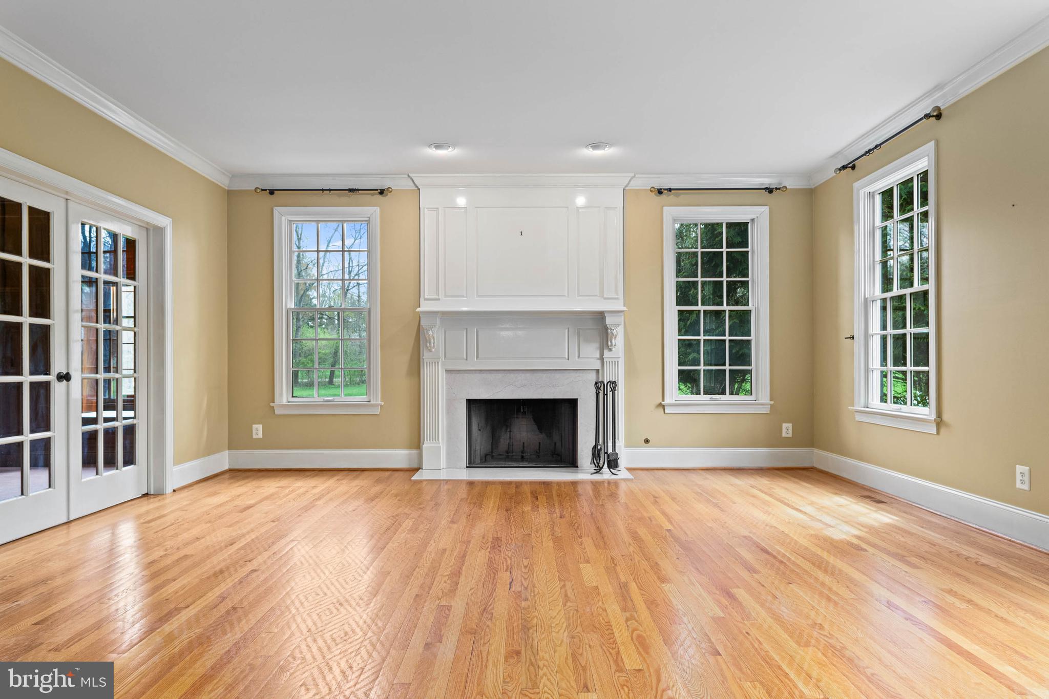 607 Newtown Road Berwyn, PA 19312 - Photo 13 of 83 a view of an empty room with wooden floor fireplace and a window