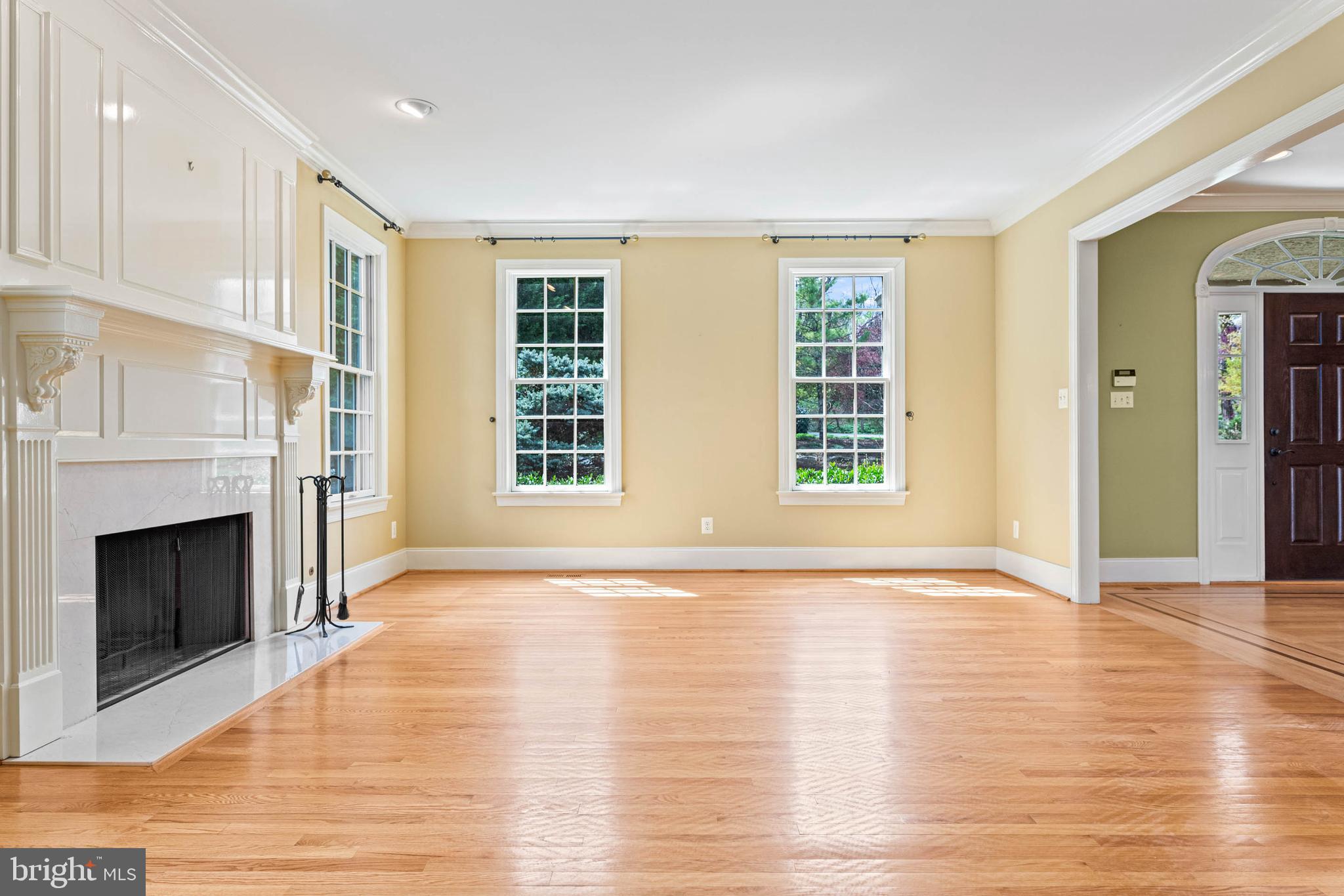 607 Newtown Road Berwyn, PA 19312 - Photo 14 of 83 a view of an empty room with wooden floor fireplace and a window