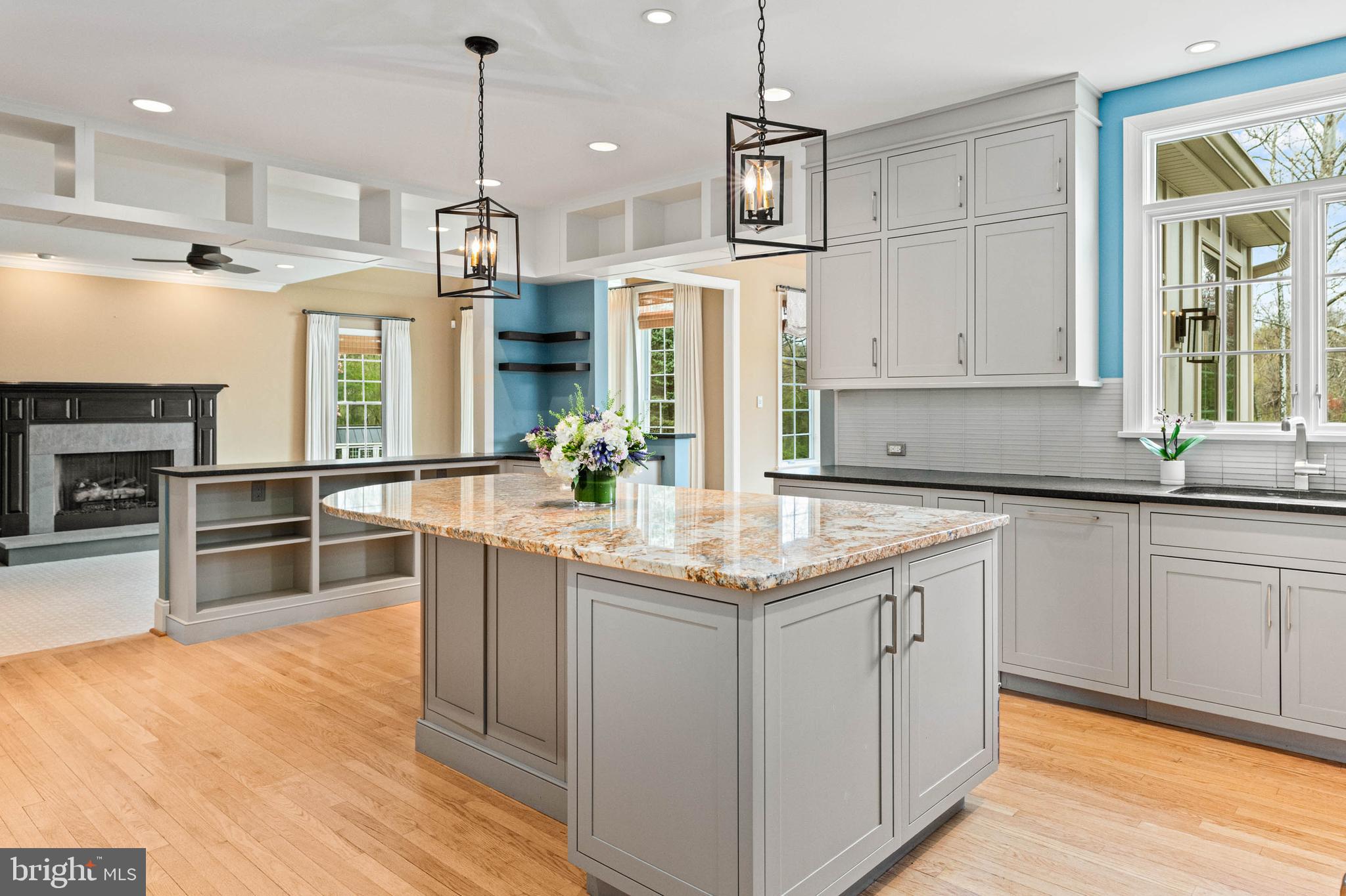 607 Newtown Road Berwyn, PA 19312 - Photo 21 of 83 a kitchen with stainless steel appliances granite countertop a sink a stove a refrigerator cabinets and living room view