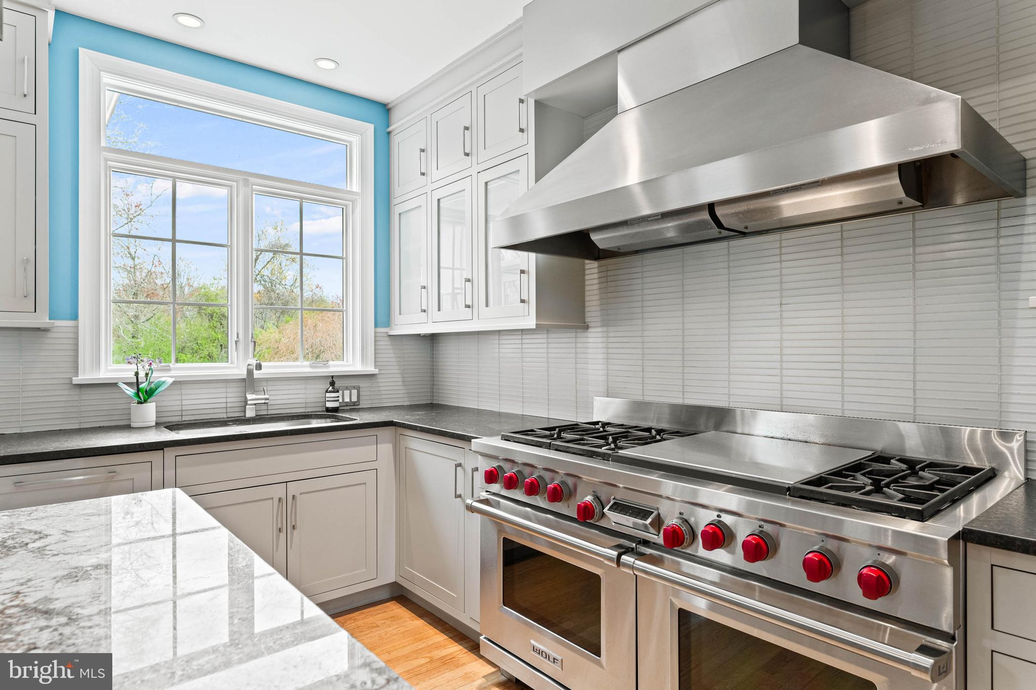 607 Newtown Road Berwyn, PA 19312 - Photo 25 of 83 a kitchen with stainless steel appliances a sink a stove and a window