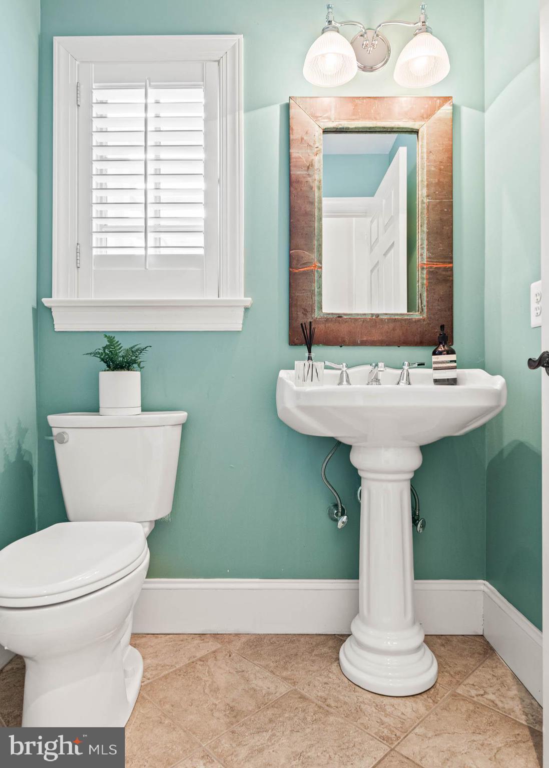 607 Newtown Road Berwyn, PA 19312 - Photo 35 of 83 a bathroom with a toilet sink and mirror
