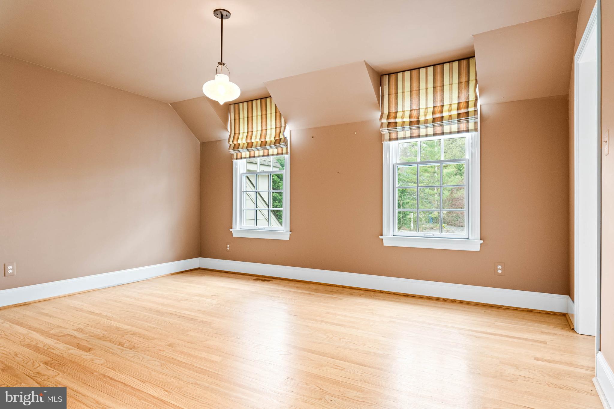 607 Newtown Road Berwyn, PA 19312 - Photo 49 of 83 a view of an empty room with wooden floor and a window