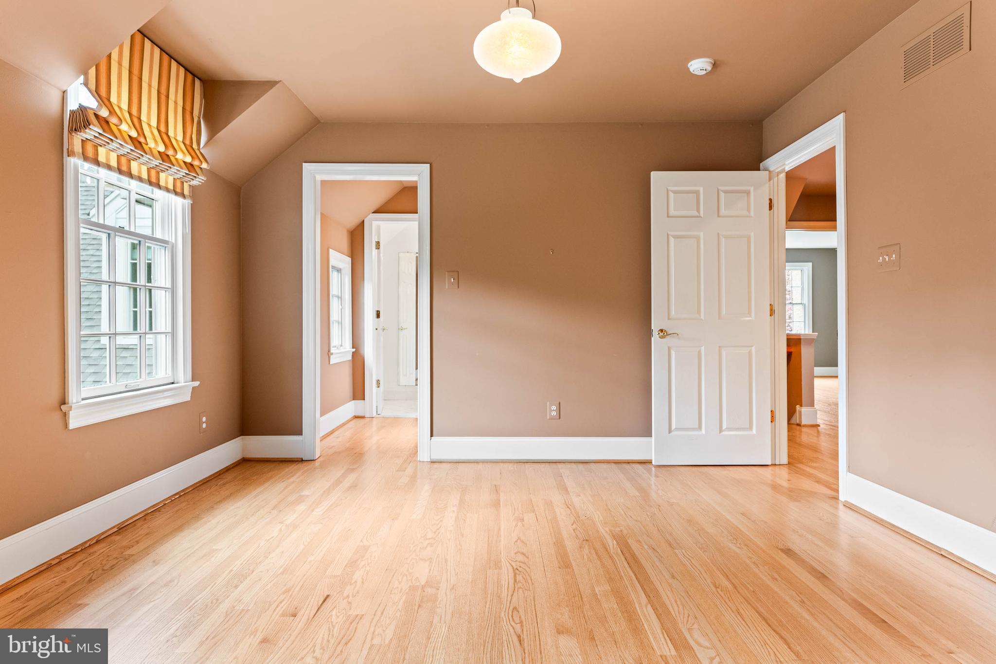 607 Newtown Road Berwyn, PA 19312 - Photo 50 of 83 a view of an empty room with wooden floor and a window