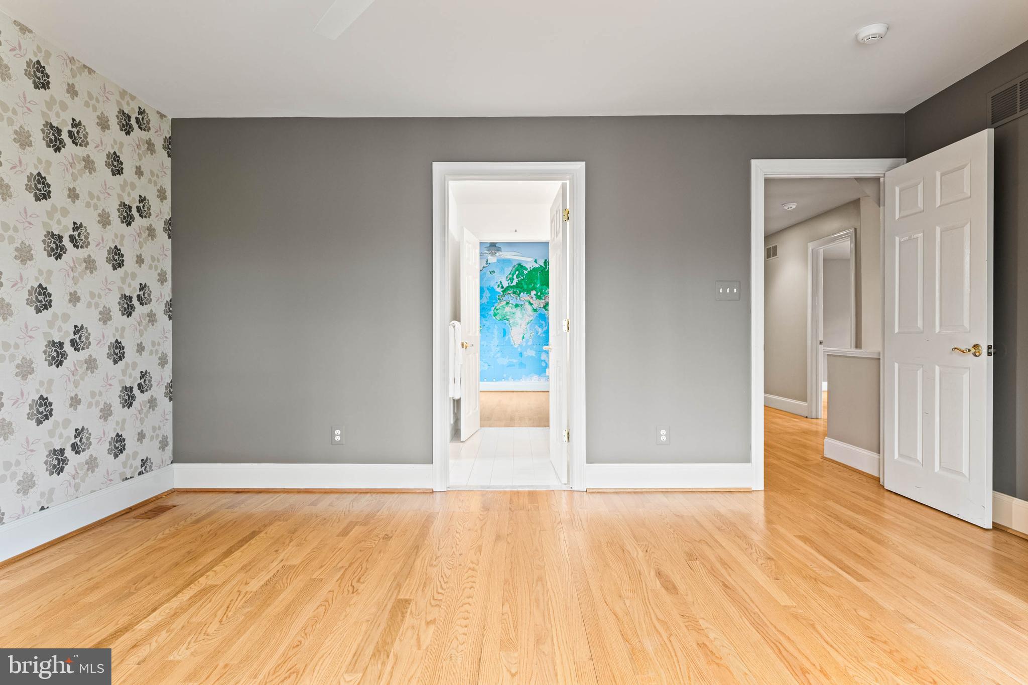 607 Newtown Road Berwyn, PA 19312 - Photo 58 of 83 a view of an empty room with wooden floor and a bathroom