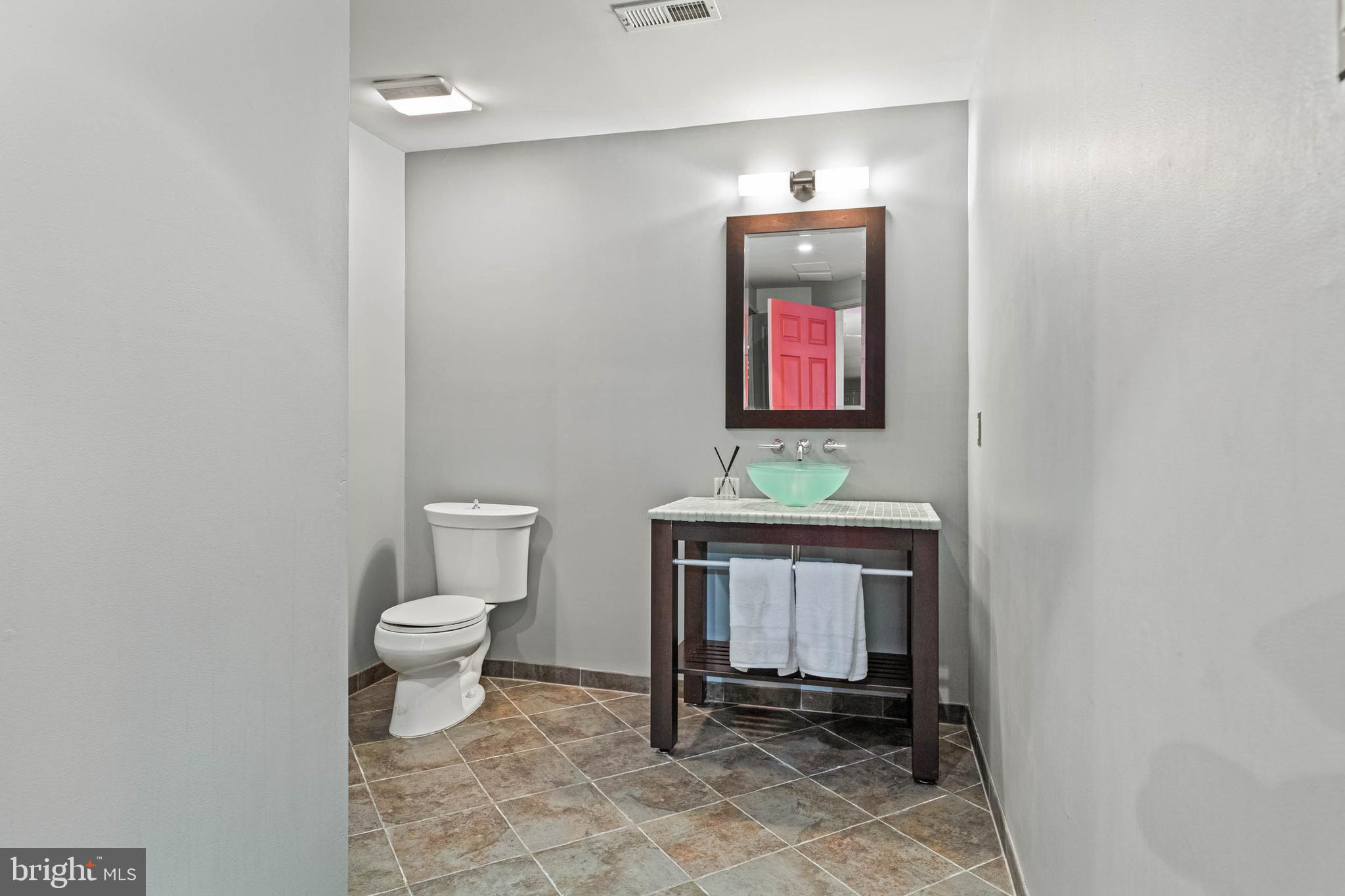607 Newtown Road Berwyn, PA 19312 - Photo 67 of 83 a bathroom with a toilet a sink and mirror