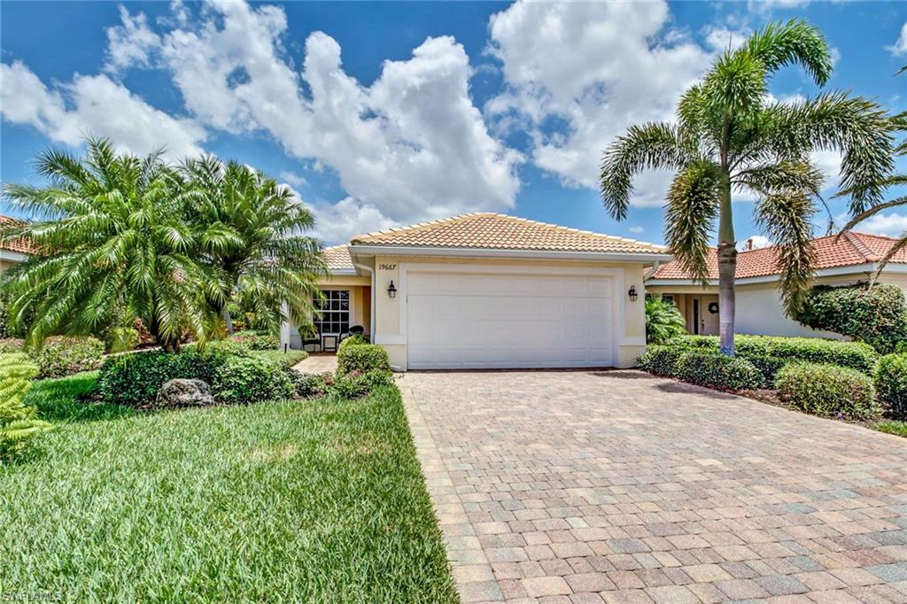 19667 Villa Rosa Loop Estero, FL 33967 - Photo 1 of 19 a front view of a house with a garden