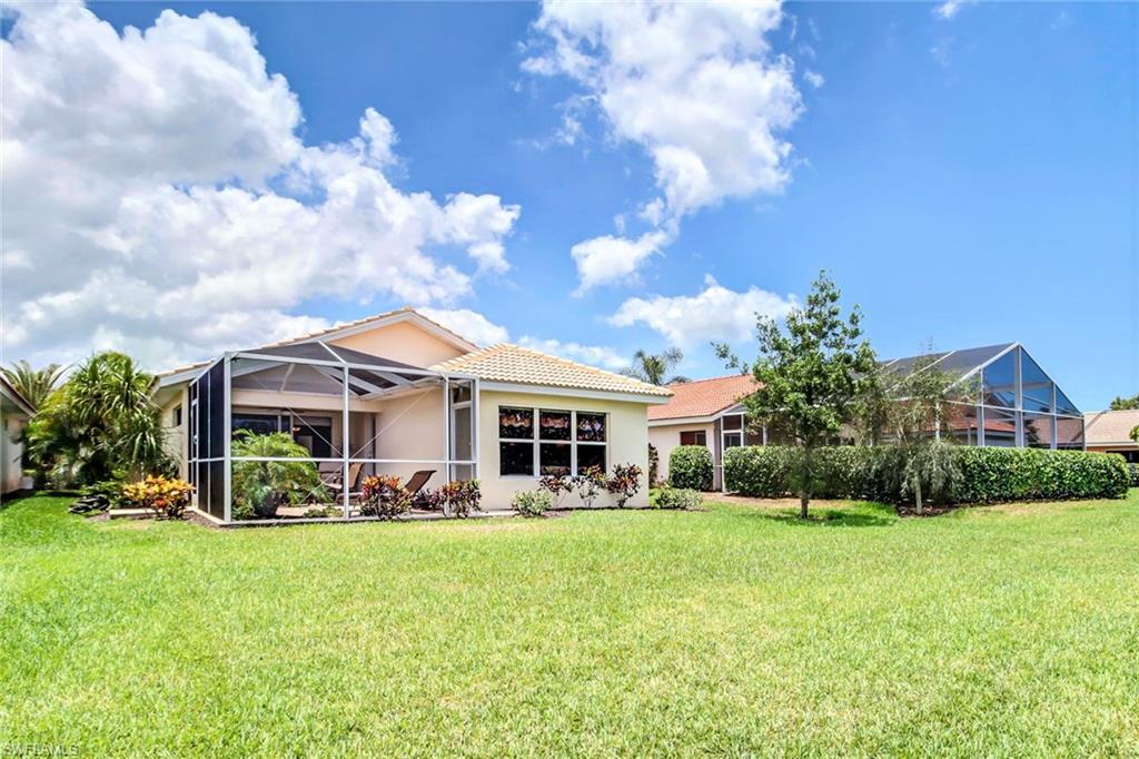 19667 Villa Rosa Loop Estero, FL 33967 - Photo 18 of 19 a front view of a house with garden