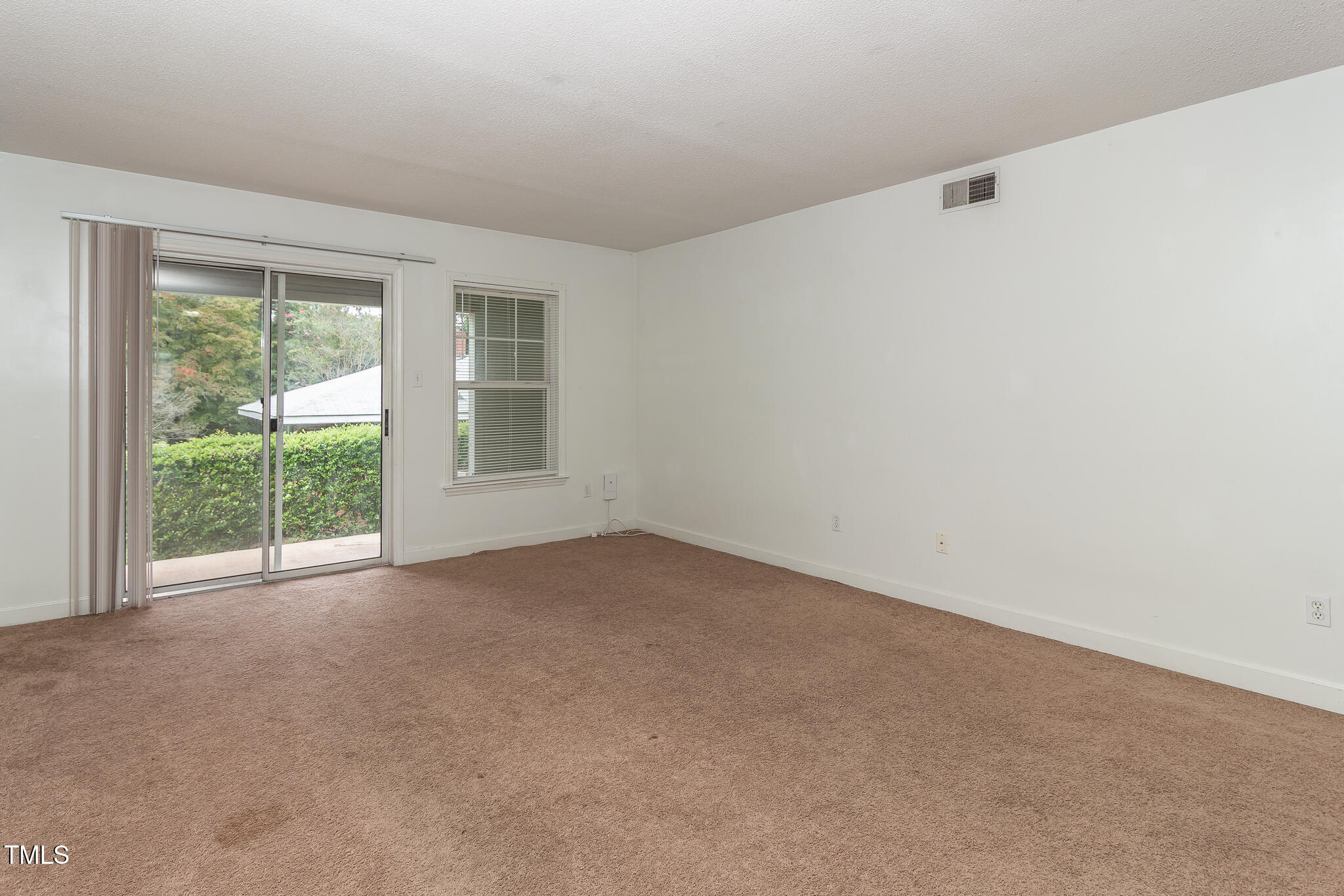 2522 Avent Ferry Road, Unit 103 Raleigh, NC 27606 - Photo 12 of 25 a view of a big room with windows and chandelier fan