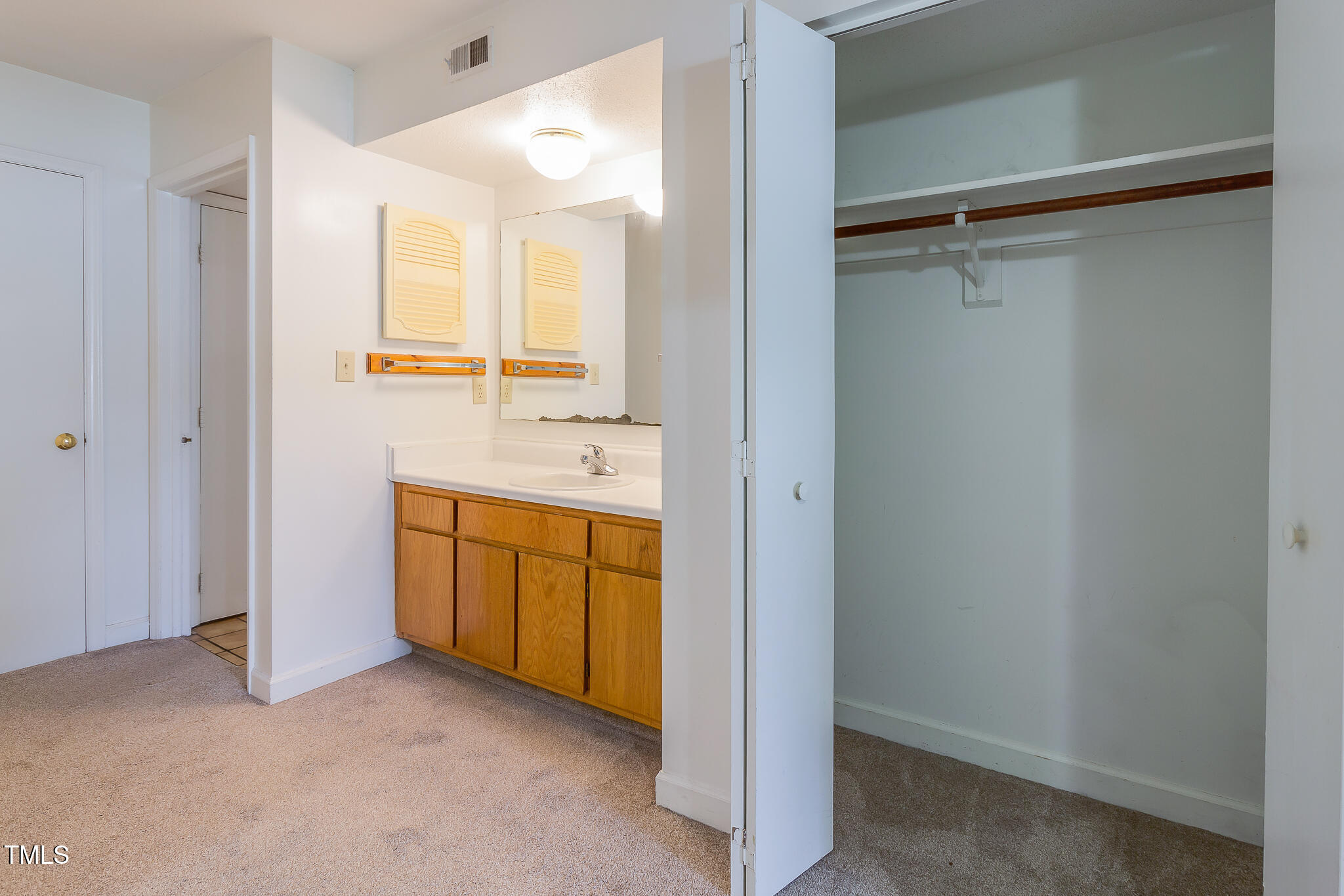 2522 Avent Ferry Road, Unit 103 Raleigh, NC 27606 - Photo 14 of 25 a bathroom with a granite countertop sink mirror and double