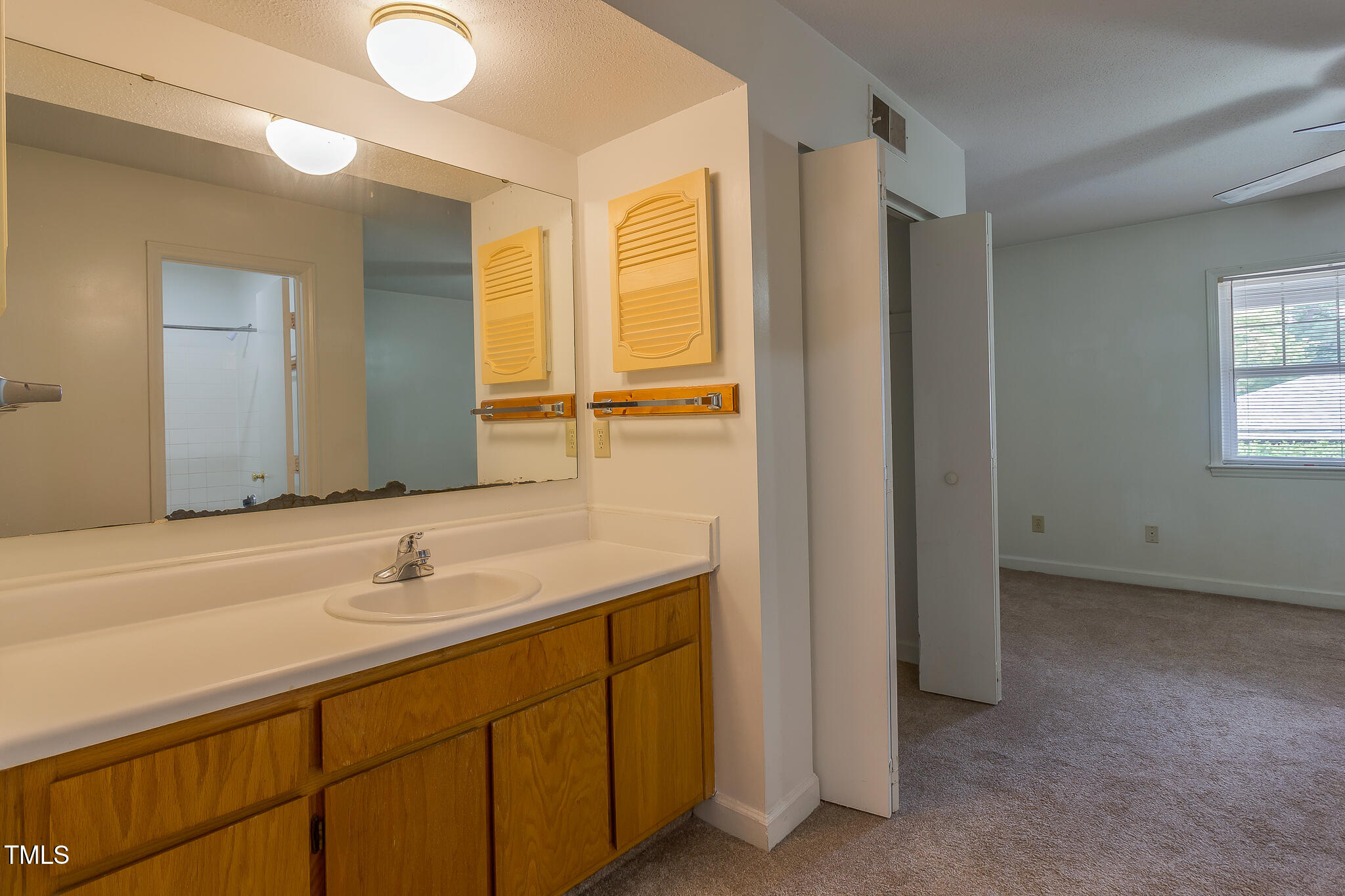 2522 Avent Ferry Road, Unit 103 Raleigh, NC 27606 - Photo 21 of 25 a bathroom with a sink and a mirror