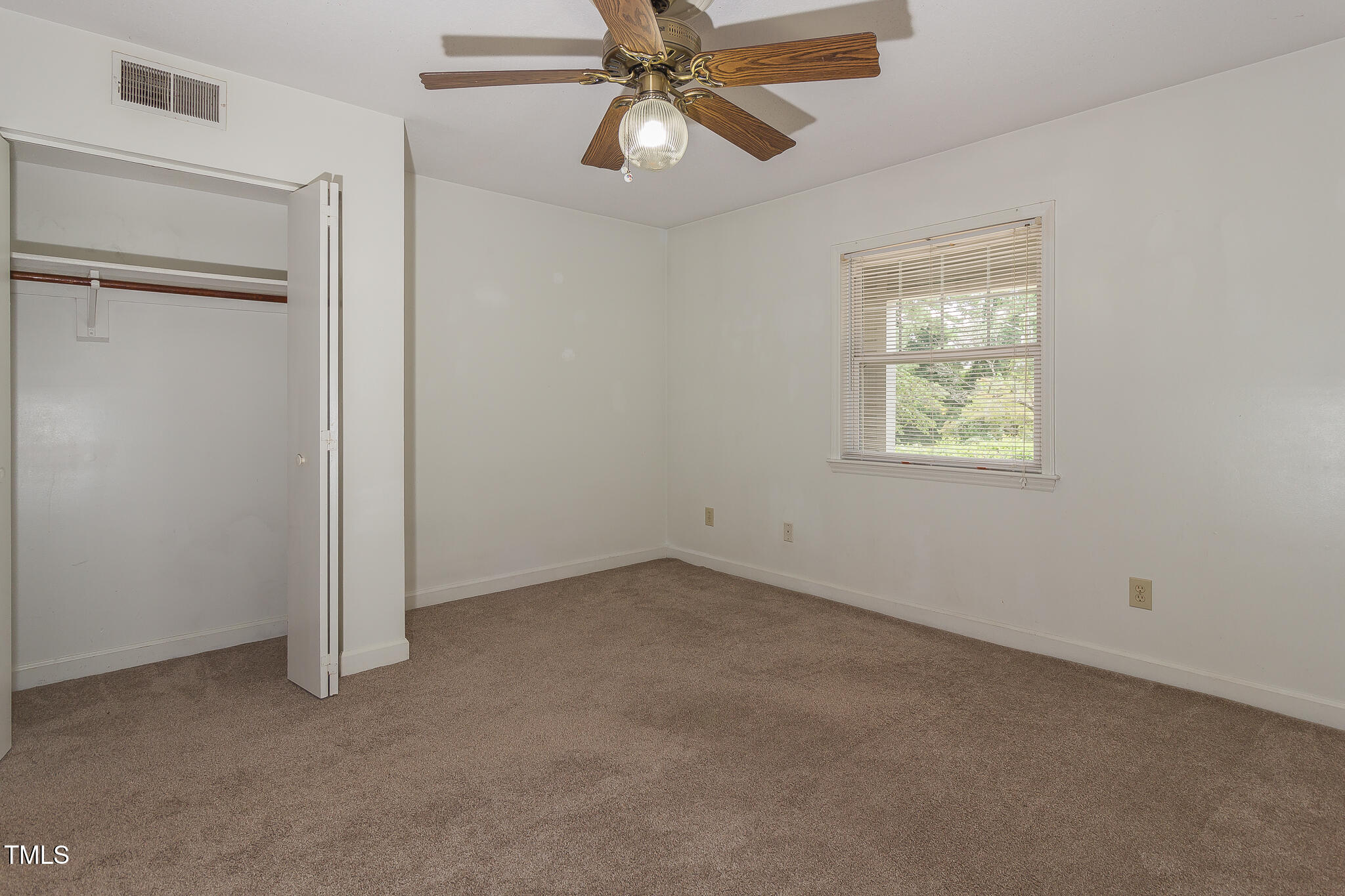 2522 Avent Ferry Road, Unit 103 Raleigh, NC 27606 - Photo 22 of 25 an empty room with a window and a fan