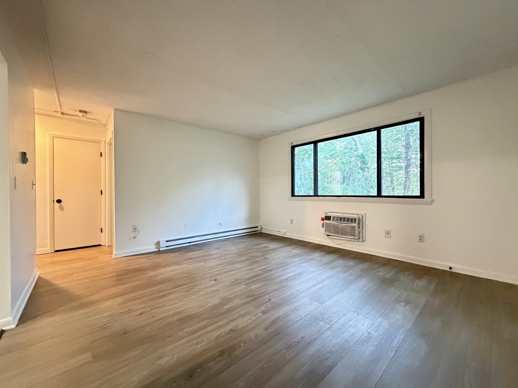 18 Pierce Street, Unit 3B Foxboro, MA 02035 - Photo 7 of 21 an empty room with wooden floor and windows