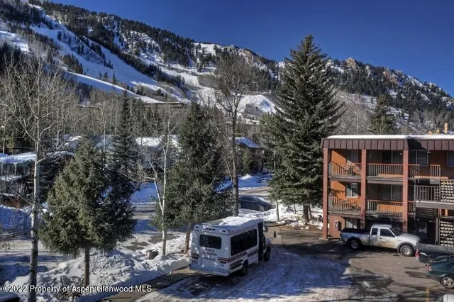 a front view of a building with trees