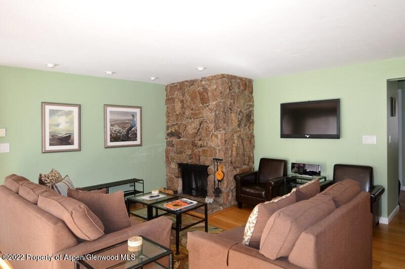 940 Waters Avenue, Unit 307 Aspen, CO 81611 - Photo 3 of 14 a living room with furniture and a fireplace