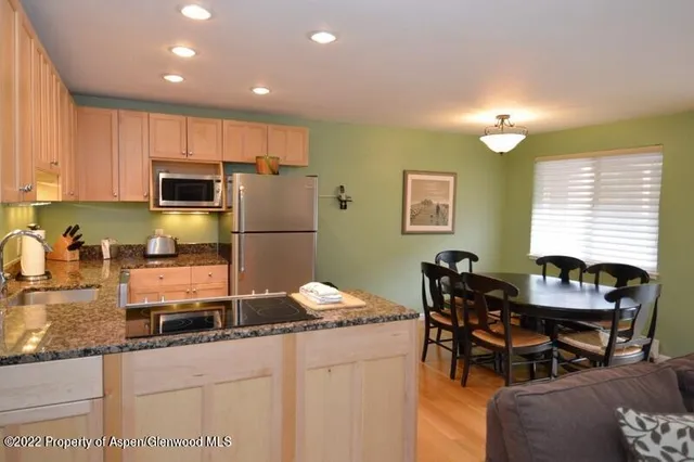 a kitchen with granite countertop sink cabinets and stainless steel appliances