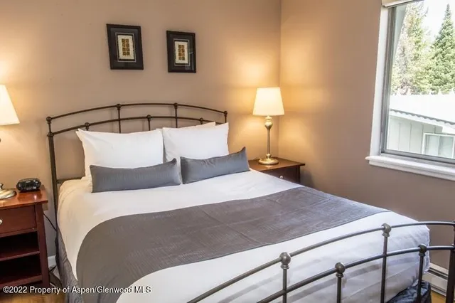 a bedroom with a bed and window