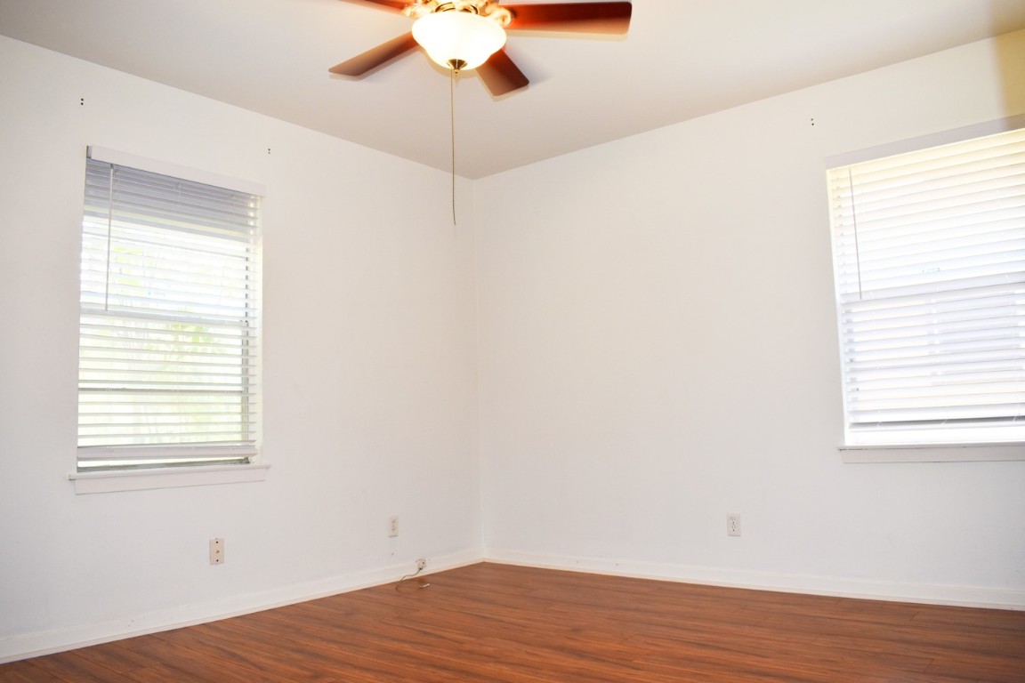 5126 Beechnut Street Houston, TX 77096 - Photo 11 of 20 a view of an empty room with wooden floor and a window