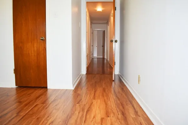 a view of a room with wooden floor