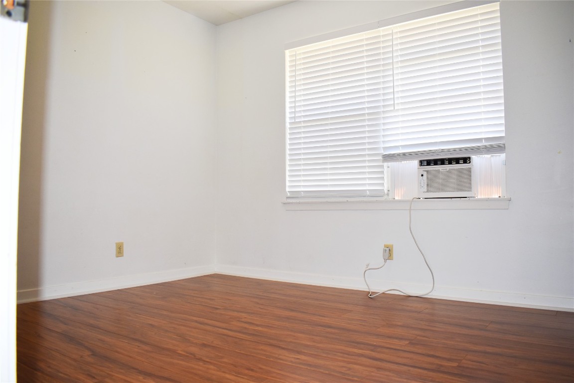 5126 Beechnut Street Houston, TX 77096 - Photo 14 of 20 a view of a room with wooden floor and a window